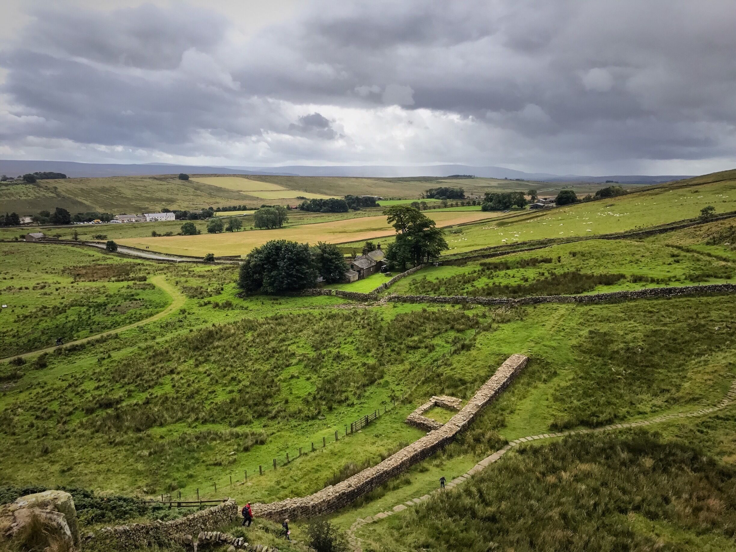 Hadrian's Wall at Once Brewed, Northumberland. The inn at Twice Brewed is in the distance. And yes they are real place names!