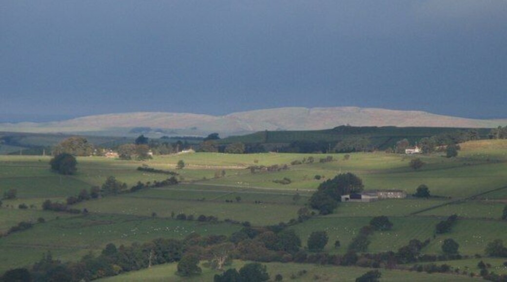 Winshield Crags The line of Hadrian's Wall on Windshields Crags is sunlit through a narrow break in the dark clouds.