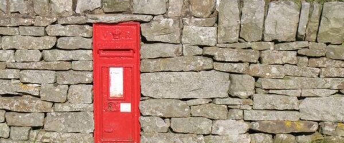 Victorian postbox in Keenley. The location of this postbox is shown in 571915. The two TV transmitter masts on Catton Beacon in NY8259 can be seen on the far horizon.
