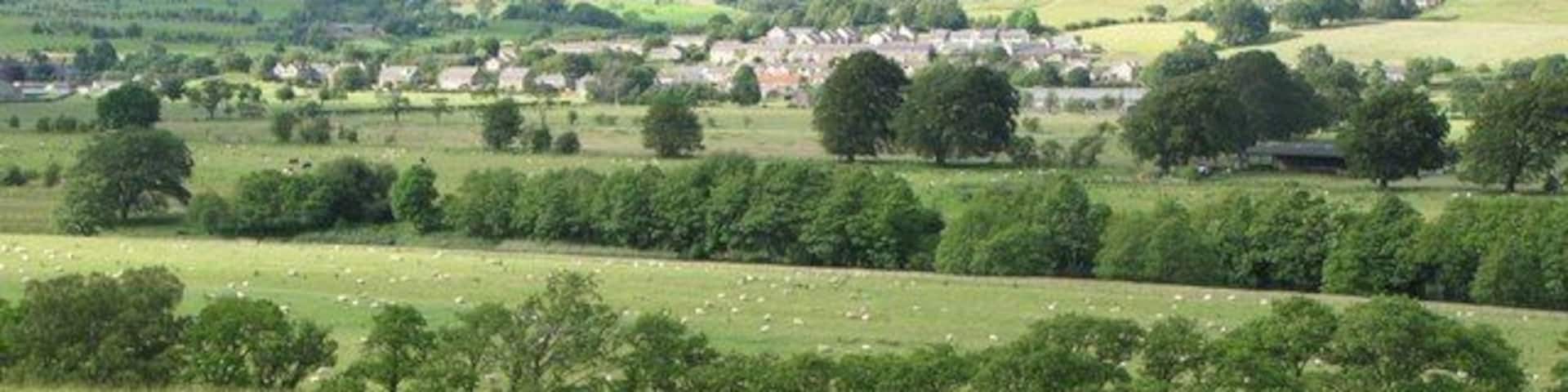 Bellingham (from the south) Bellingham spreads itself across this grid square and NY8383. On the horizon (right) are Callerhues Crags in NY8486 and NY8586. The farm which appears to be just below the crags is Blakelaw in NY8484.