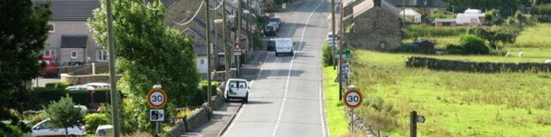 Entering West Woodburn from the North along the A68 Looking down the hill towards West Woodburn.