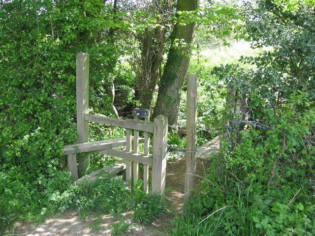 Stile on the path from Glovers Road, Charlwood to Glovers Wood Note the barrier that can be lifted to let your dog through and the gap to the side that most dogs actually use.
