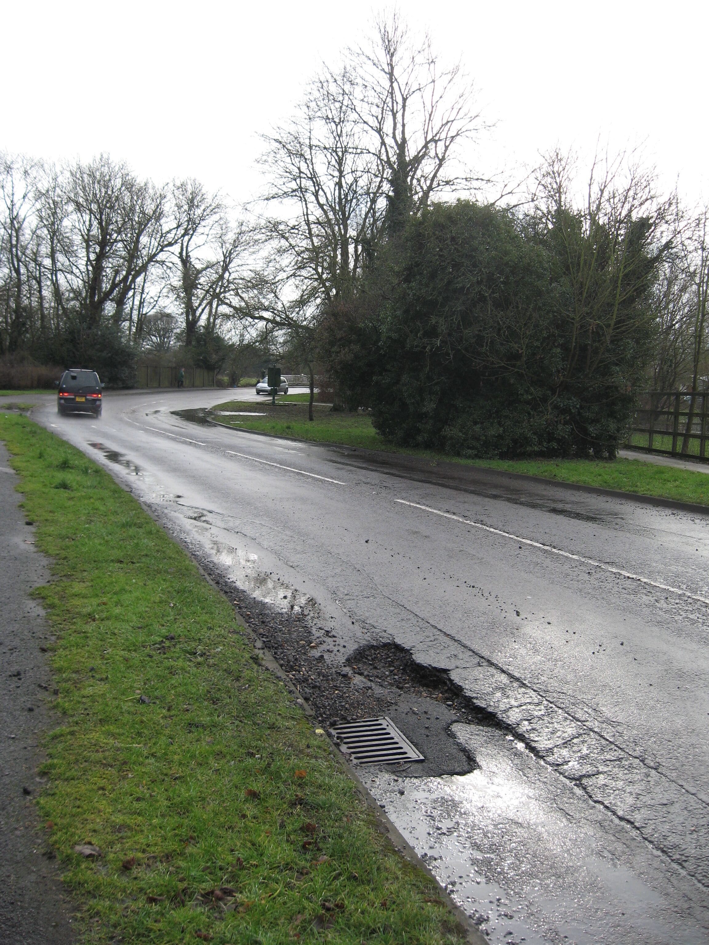 Lee Street, Horley, approaching the bridge over the River Mole The ravages of a cold winter can be seen at the edge of the road. I wonder how long it will be before it is repaired?