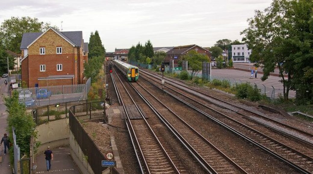 Towards Horley Station. Looking south from the footbridge in 1727230. On the left can be seen the subway built to replace the level crossing at this site after Station Road was severed when the London to Brighton railway was quadrupled in 1903. The original 1841 Horley Station was here, before being replaced in 1905 by the current one, seen in the background. A Southern Class 377 Electrostar is approaching on the up fast line on a London bound service. In the background, another London bound Class 377 waits in the station on the up slow line, while a Gatwick Airport bound Class 460 Gatwick Express can just be seen having passed through the station on the down fast line (the left hand track).