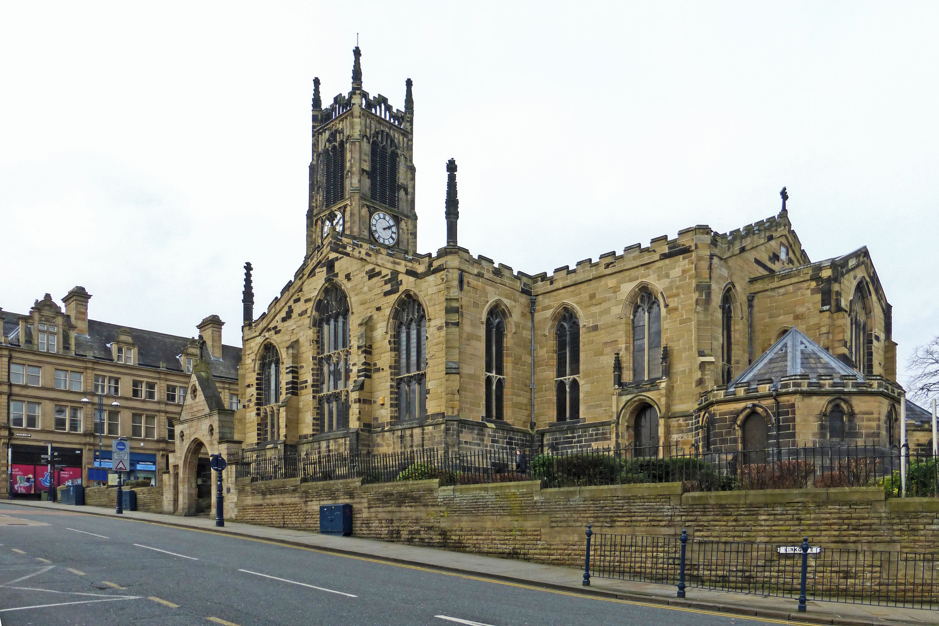 A historic church with a tall clock tower and arched windows.