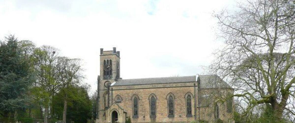 A church with a bell tower and arched windows.