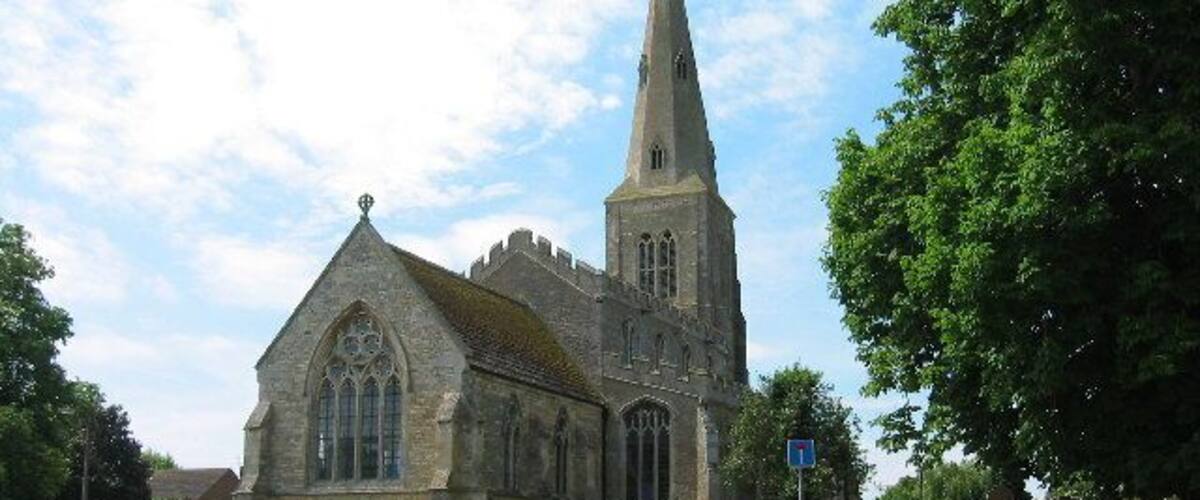 A historic church with a tall spire and a stone facade.