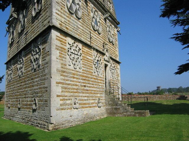 A stone tower with intricate carvings and a clock.