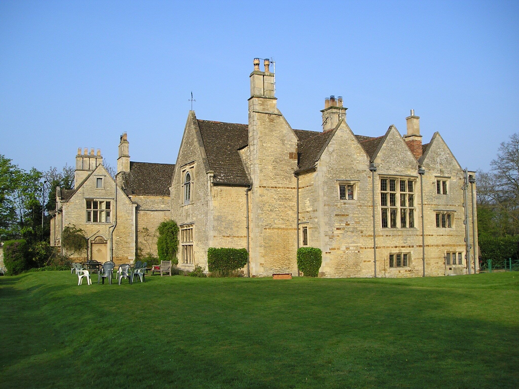 A large stone building with multiple chimneys and windows.