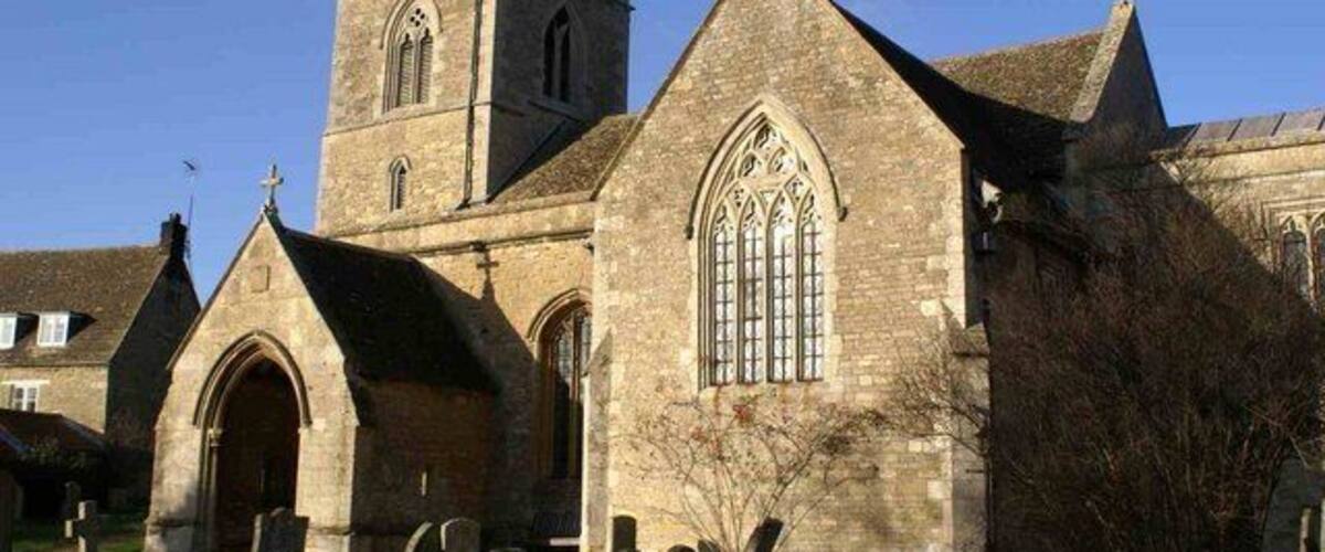 A historic church with a prominent tower and arched windows.