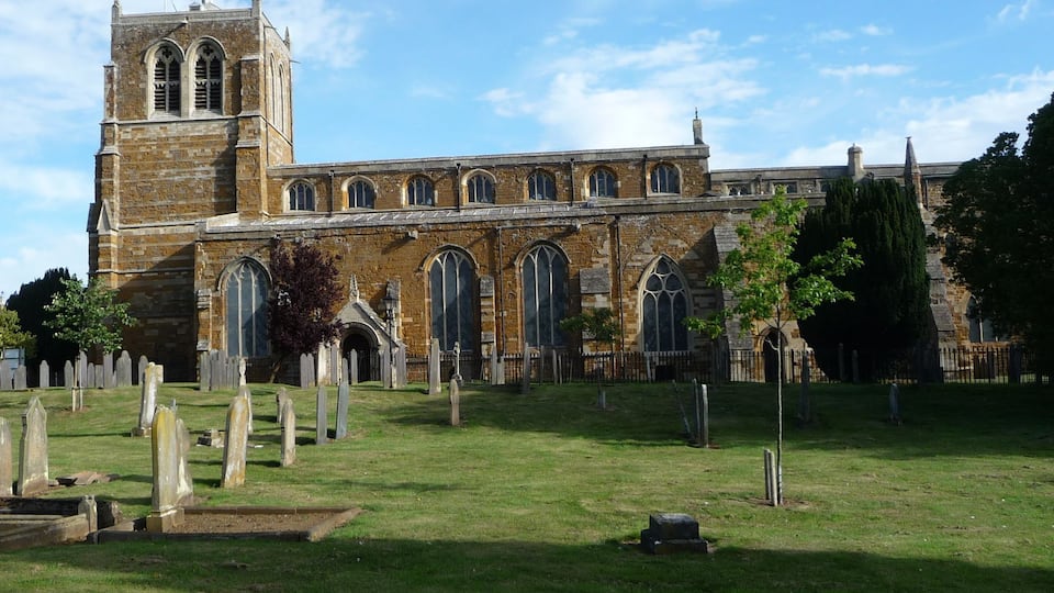 A historic church with a tall tower and arched windows.