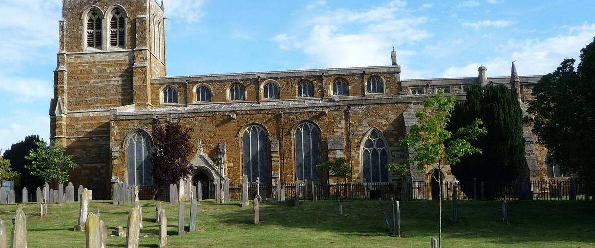 A historic church with a tall tower and arched windows.