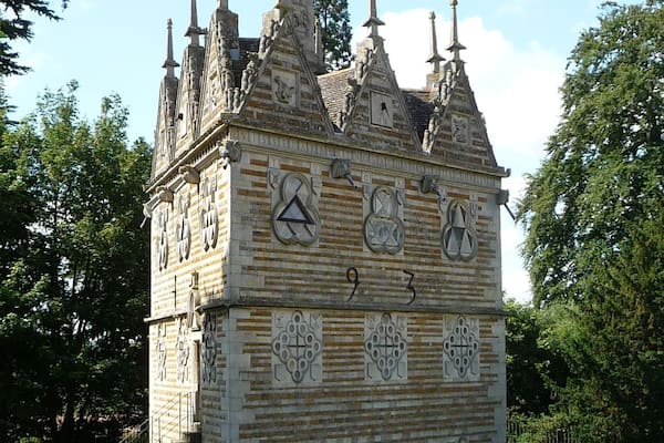 A historic building with intricate stone carvings and multiple spires.