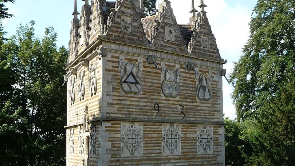 A historic building with intricate stone carvings and multiple spires.