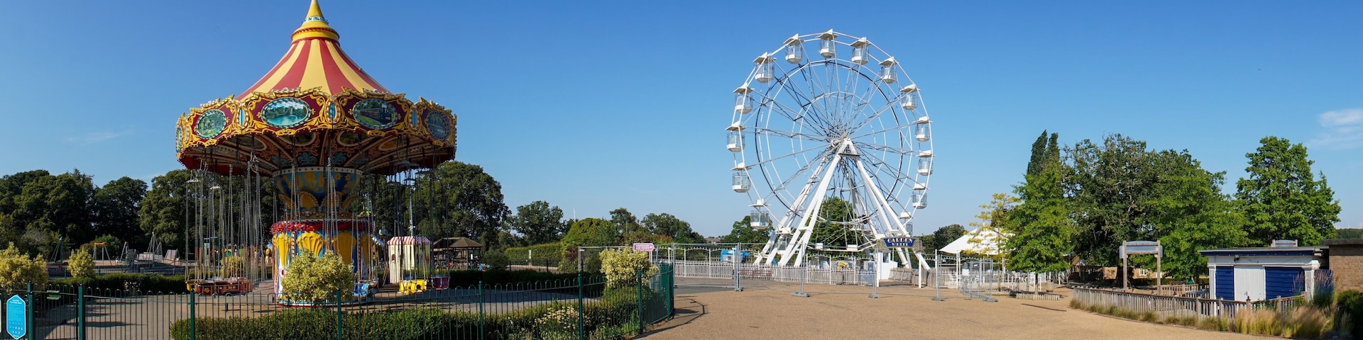 A carousel and a Ferris wheel at an amusement park.