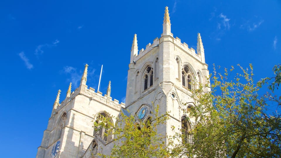A historic church with twin towers and a large clock.