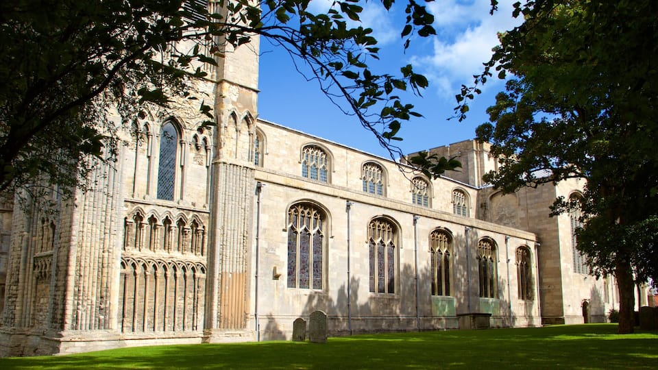A historic stone building with large arched windows and intricate stonework.