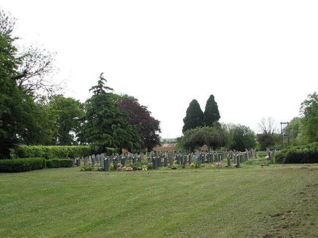 New cemetery east of St Mary's church. The new section of the churchyard is separated from the old by a track called Eaton Drove > 1300331.