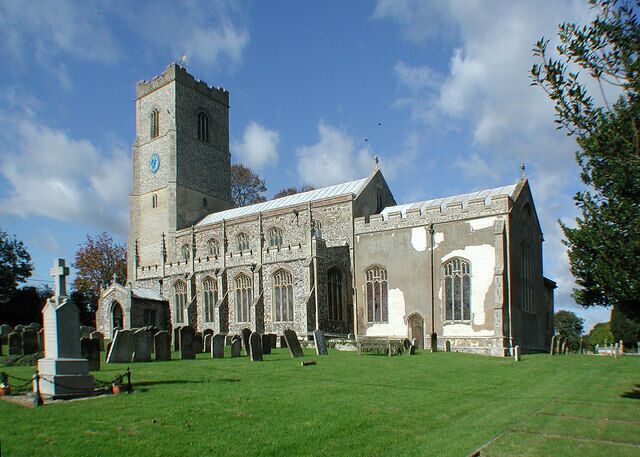 St Martin's parish church, Fincham, Norfolk, seen from the southeast, with the parish war memorial on the left