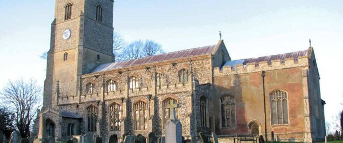 St Martin's church illuminated by winter sunlight. The war memorial can be seen in the foreground. St Martin > 1636596 is one of formerly two churches in the village of Fincham. St Michael's church (abandoned in 1745 after the collapse of its tower) used to be situated about 200 metres to the west and after it was pulled down some of it was used to repair St Martin. The church sits on an elevation north of High Street, the main thoroughfare through the village. The building dates mainly from the 15th century but was restored in the mid to late 1800s when the south porch was added. The stained glass windows > 1636627 date from that time also. The vestry on the north side dates from around 1503 and has an extra room above for the use of an assistant priest. The rood screen with its elaborately carved tracery and original painted decoration on the panels > 1636640 is C15. The most notable feature of the church is the magnificent Norman font > 1636645 which came from St Michael's church. It is only one of 13 square Norman fonts that still survive in north-west Norfolk and one of only three which have figures carved on the sides of the bowl. Six boards dating from 1717 and inscribed with texts from the Bible > 1636606 hang on the nave walls. The pulpit and pews were installed in Victorian times.