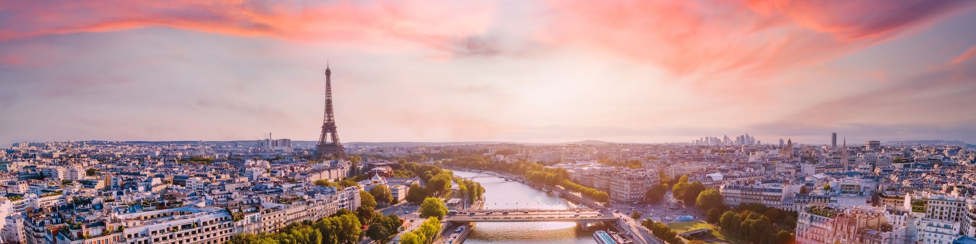A cityscape with the Eiffel Tower, a river, and a bridge.