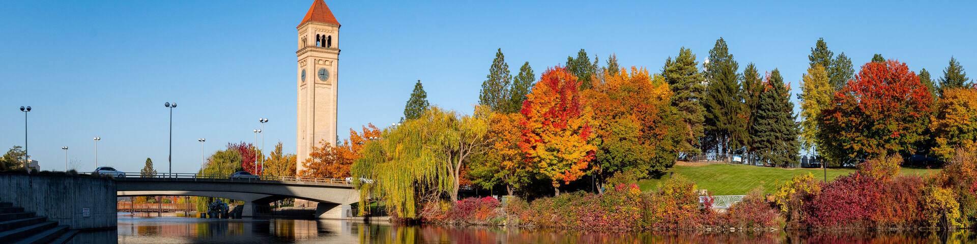 Panorama of Spokane River Reflecting a Colorful Riverfront Park during Autumn in Downtown Spokane, WA