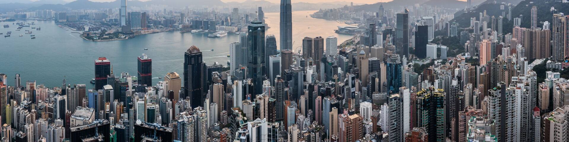 Hong Kong skyline and harbor panoramic at sunrise