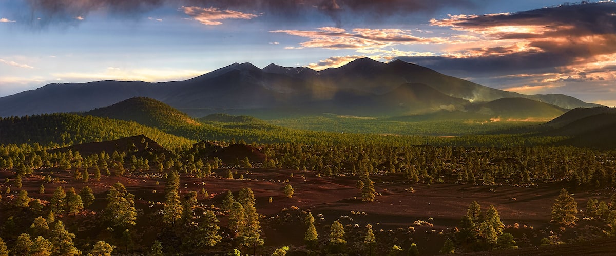 Cloudy sunset sky with rolling clouds and mountains. The San Francisco Peaks, Arizona