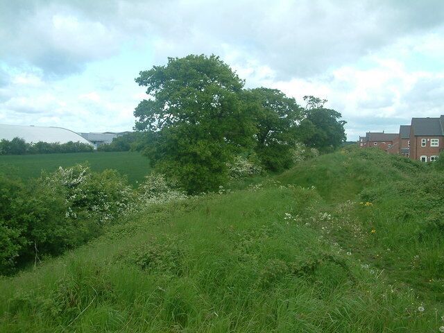 The industrial estate, the field and the housing estate. Viewed from the raised embankment this photograph shows the housing estate separated by a field from the industrial estate.