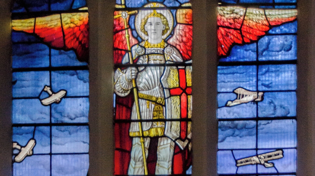 The background for this window consists of clouds coloured in airforce blue and the view of Lincoln Cathedral is seen from the air and was taken from a photograph provided by the RAF. The window comprises of 3 lights:- The centre light portrays St Michael the Archangel, fully armed, as patron of the Church Militant, piercing the Dragon of Evil, standing sentinel over the Cathedral of Lincoln. The Right Side Light shows various types of aeroplanes ascending, such as were flown by pilots at that time. These include the Sopwith Camel, Blackburn Bombers and Avros. There is also a distant view of an early submarine on the surface of the sea. The left hand light contains views of aeroplanes descending to their Hangers in the left foreground. At the top of the Lights can be seen four smaller lights. These feature the badges of the Royal Flying Corps, The Royal Naval Air Service, The Royal Air Force together with The Royal Flying Cross. The window was designed by Messrs Burlison & Grylls of 36, Great Ormond Street, London, WC1, from suggestions made by the Rev Alfred Hunt MA, Vicar of Welton, and was first unveiled and dedicated by the Lord Bishop of Lincoln on 10th May 1921. This unique Memorial Window created considerable interest nationally and among the first to visit was Sir William Tritton the inventor of the Modern Tank. (From Church Guide Book)
