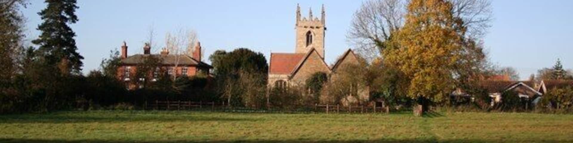 Norton Disney: St.Peter's church and vicarage seen from the approaching footpath.