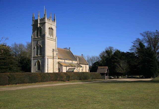 A church with a tall tower and a small adjacent building.