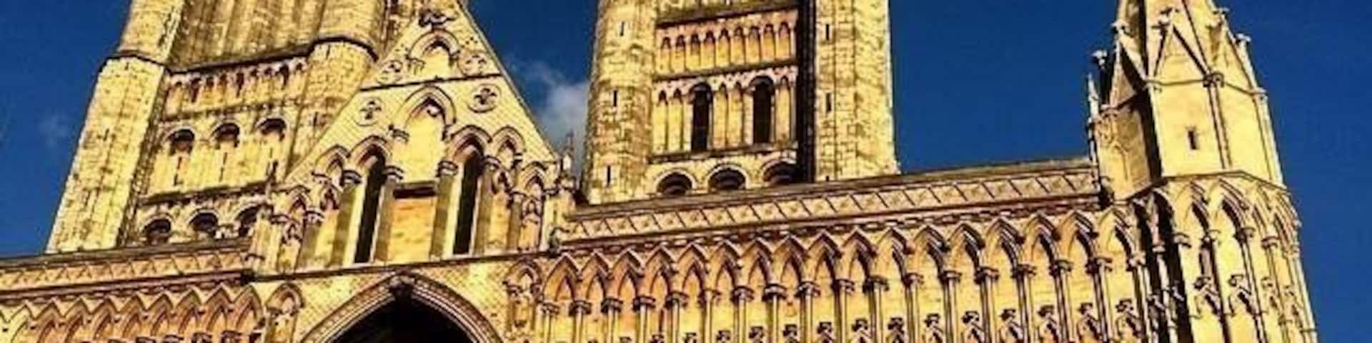 A large cathedral with two tall spires and intricate stonework.