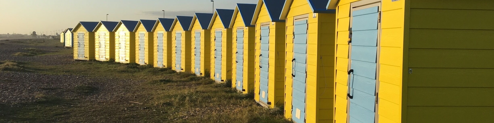 Littlehampton beach huts. There is a row going the other way all green.