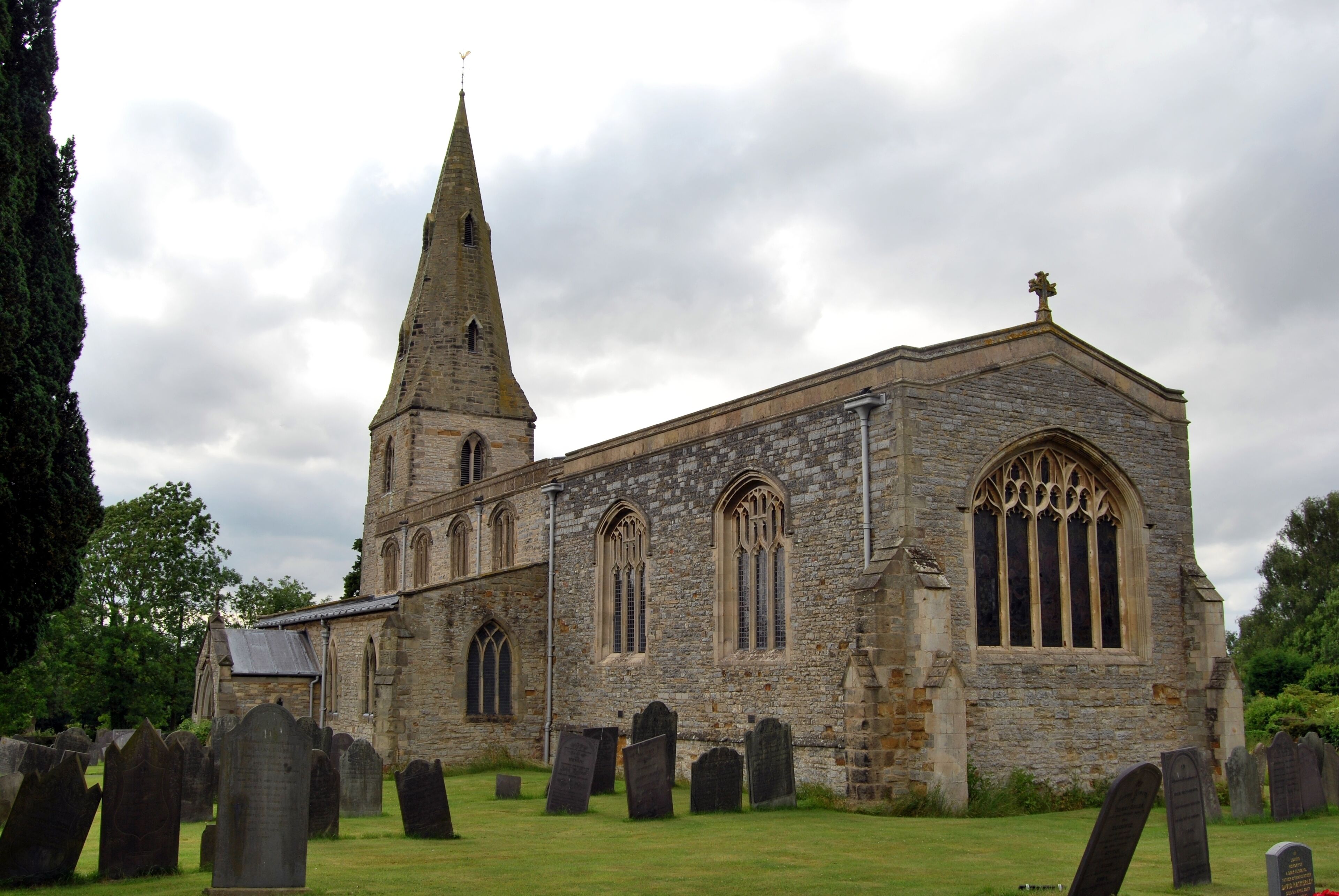 A historic church with a tall spire and Gothic windows.