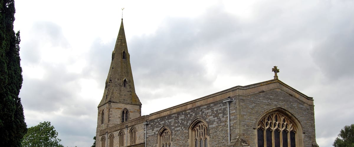 A historic church with a tall spire and Gothic windows.