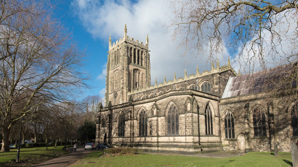A historic church with a tall tower and arched windows.