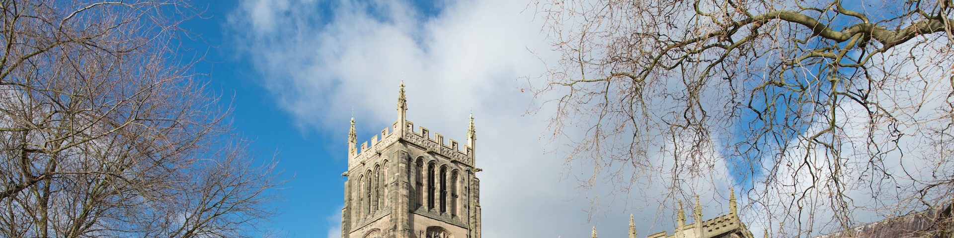A historic church with a tall tower and arched windows.