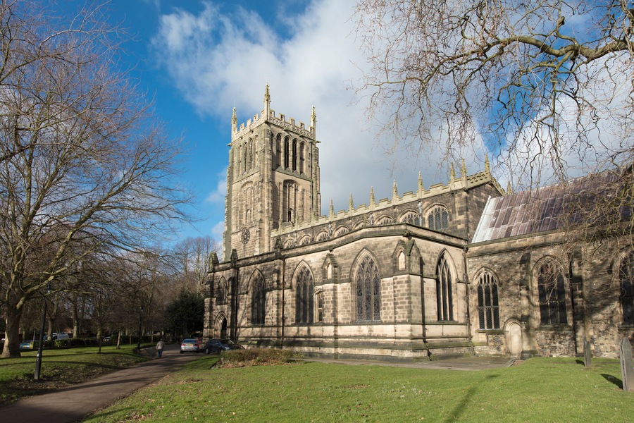 A historic church with a tall tower and arched windows.