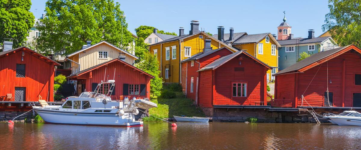 A harbor with colorful wooden houses and boats.