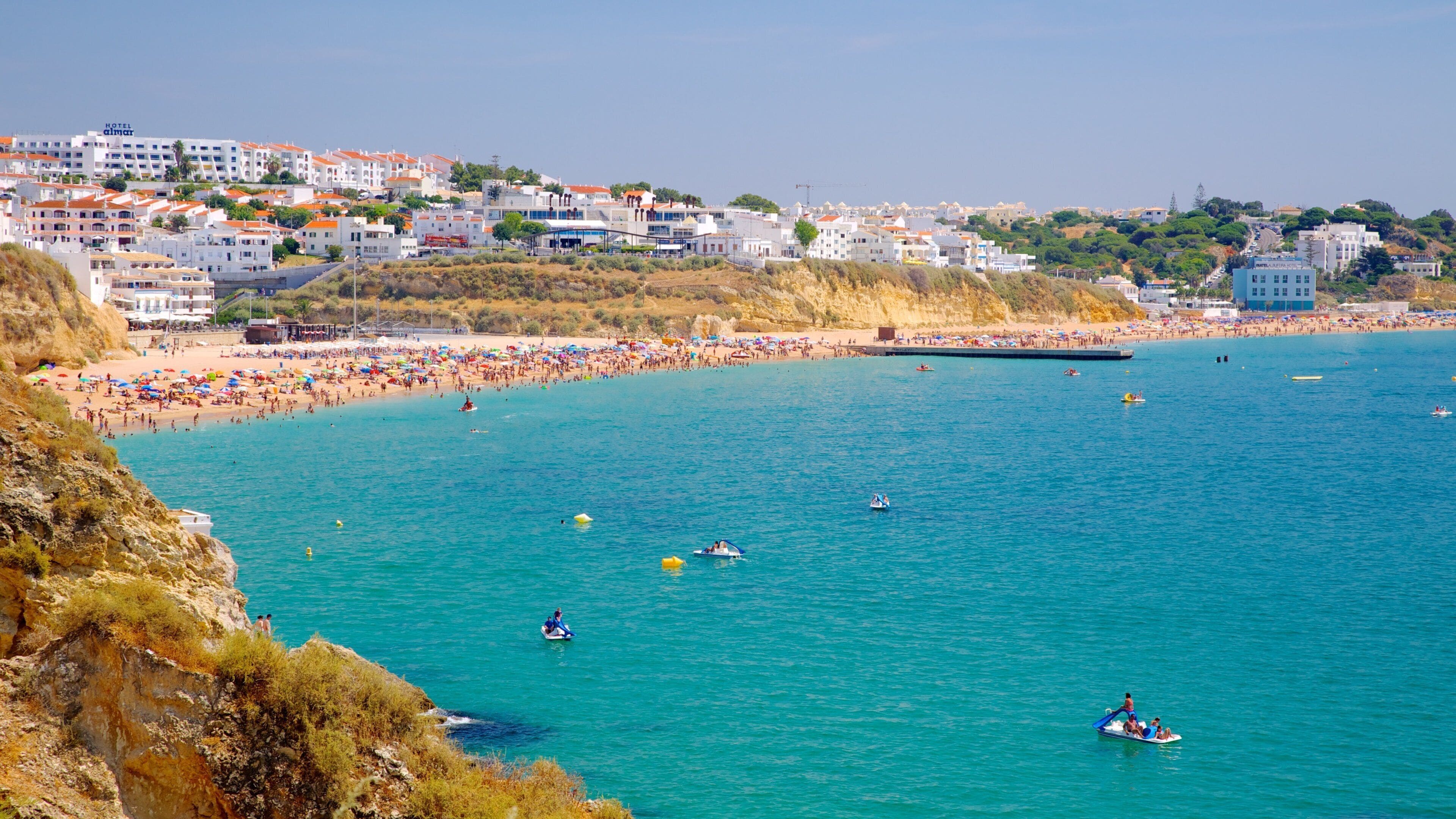 Albufeira showing a sandy beach, swimming and a coastal town