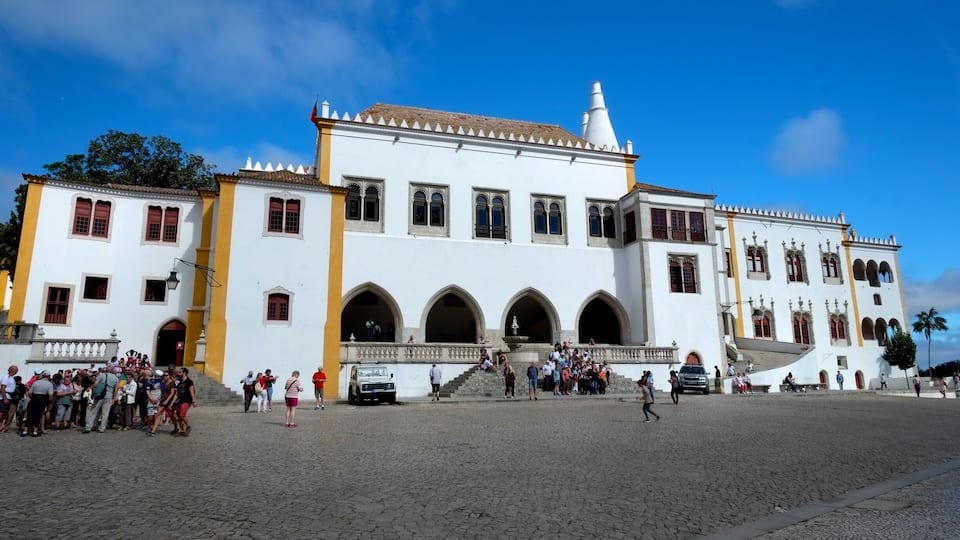 The Palace of Sintra is located in the town of Sintra, in the Lisbon District of Portugal. It is a present-day historic house museum.
It is the best-preserved medieval royal residence in Portugal, being inhabited more or less continuously from at least the early 15th century to the late 19th century. It is a significant tourist attraction, and is part of the cultural landscape of Sintra, a designated UNESCO World Heritage Site.
