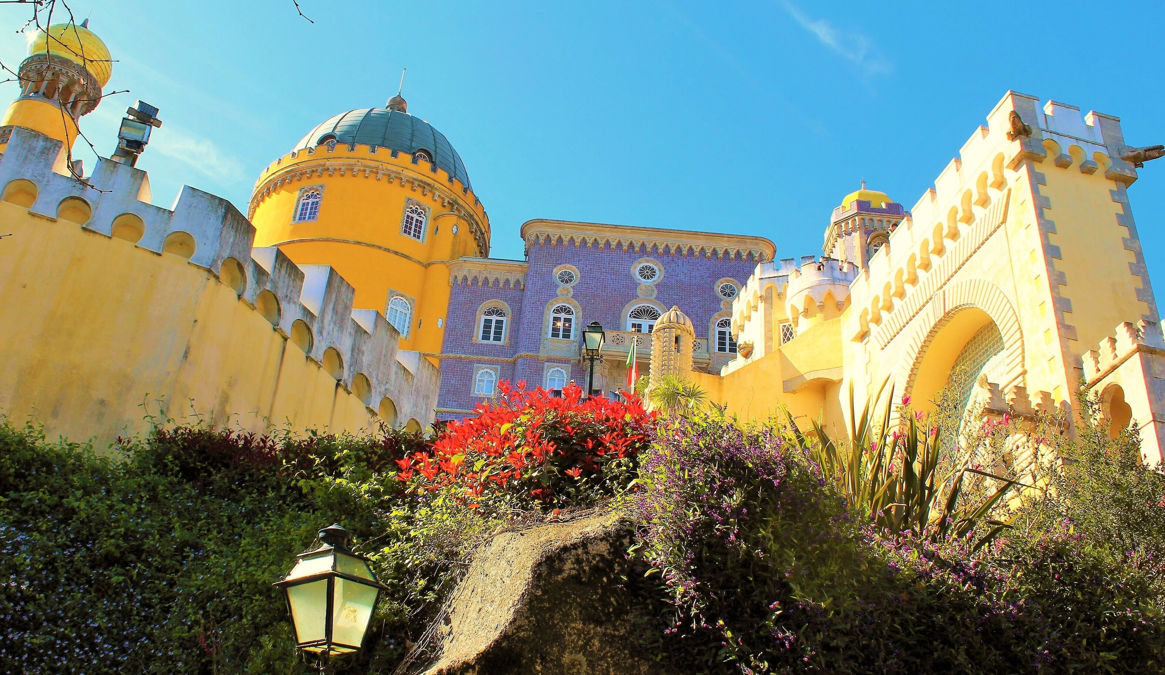 I took this in March in Sintra, Portugal! It's at the fairy tale castle Pena Palace :). This is one of the lovely close-up views. It's is a Romanticist castle that stands on the top of a hill in the Sintra Mountains. And undoubtedly one of the most iconic places in Portugal. And a dream come true to visit it! It is a national monument and constitutes one of the major expressions of 19th-century Romanticism in the world. The palace is a UNESCO World Heritage Site and one of the Seven Wonders of Portugal. It is also used for state occasions by the President of the Portuguese Republic and other government officials. Thanks to Wikipedia for help ;).