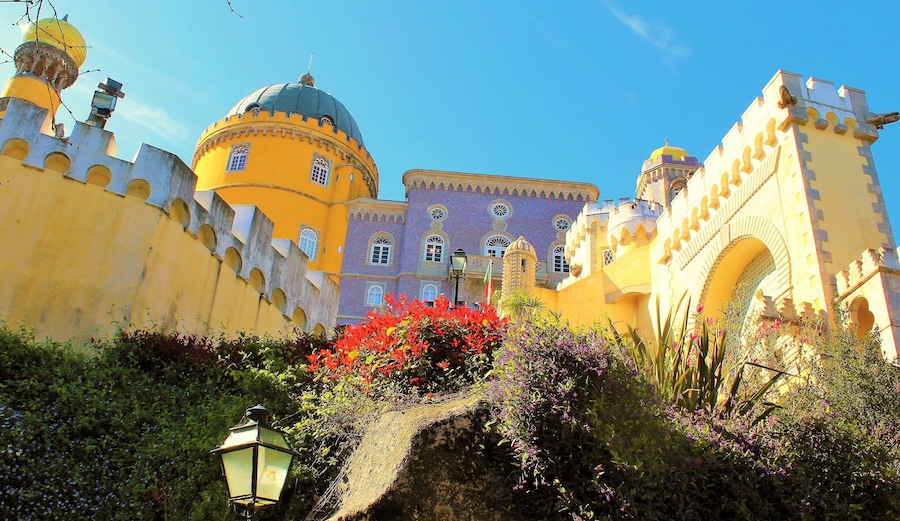 I took this in March in Sintra, Portugal! It's at the fairy tale castle Pena Palace :). This is one of the lovely close-up views. It's is a Romanticist castle that stands on the top of a hill in the Sintra Mountains. And undoubtedly one of the most iconic places in Portugal. And a dream come true to visit it! It is a national monument and constitutes one of the major expressions of 19th-century Romanticism in the world. The palace is a UNESCO World Heritage Site and one of the Seven Wonders of Portugal. It is also used for state occasions by the President of the Portuguese Republic and other government officials. Thanks to Wikipedia for help ;).