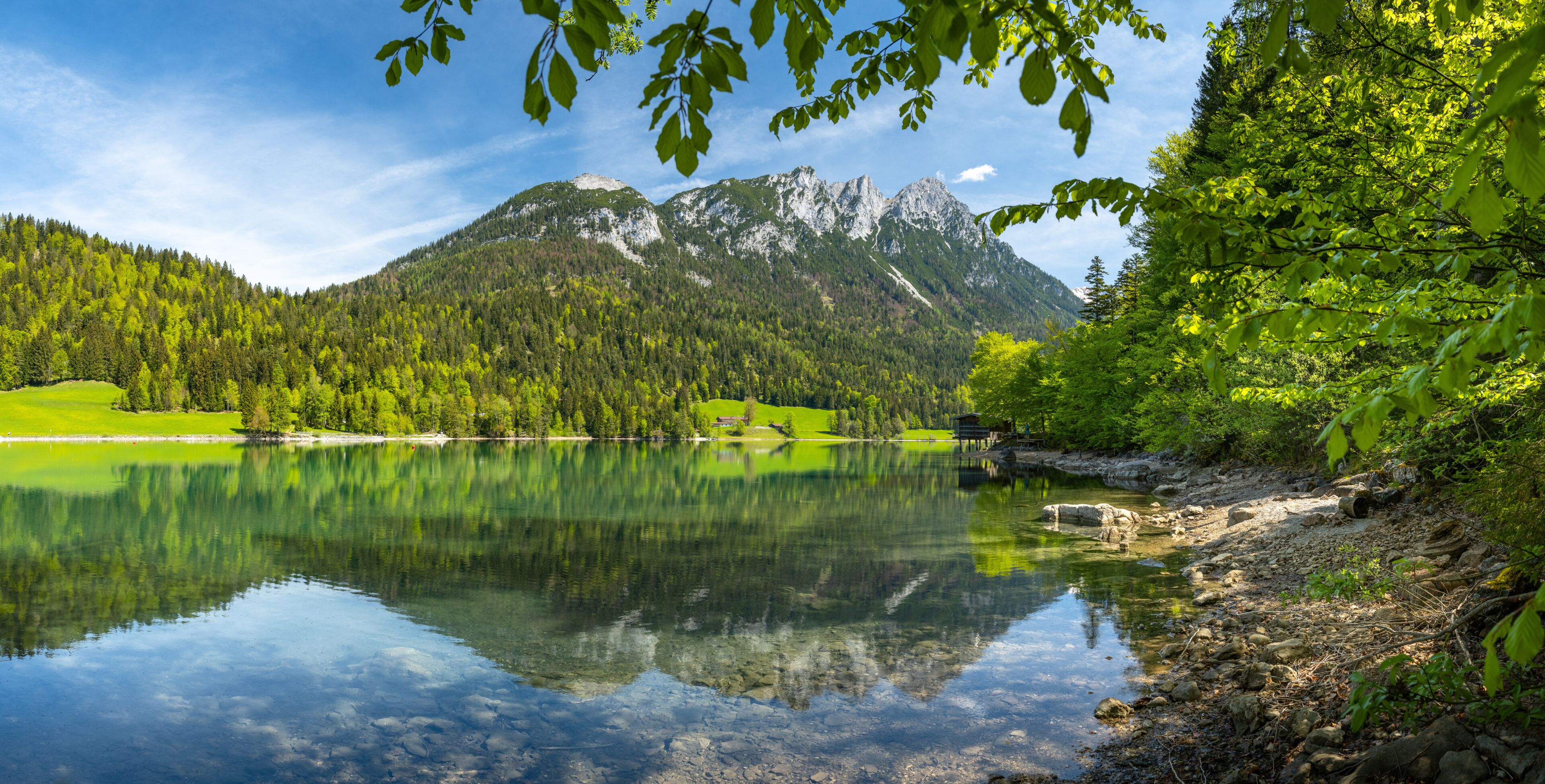 The Wilder Kaiser mountain range is reflected in the idyllic Hinterseiner See, Tyrol, Austria, Europe