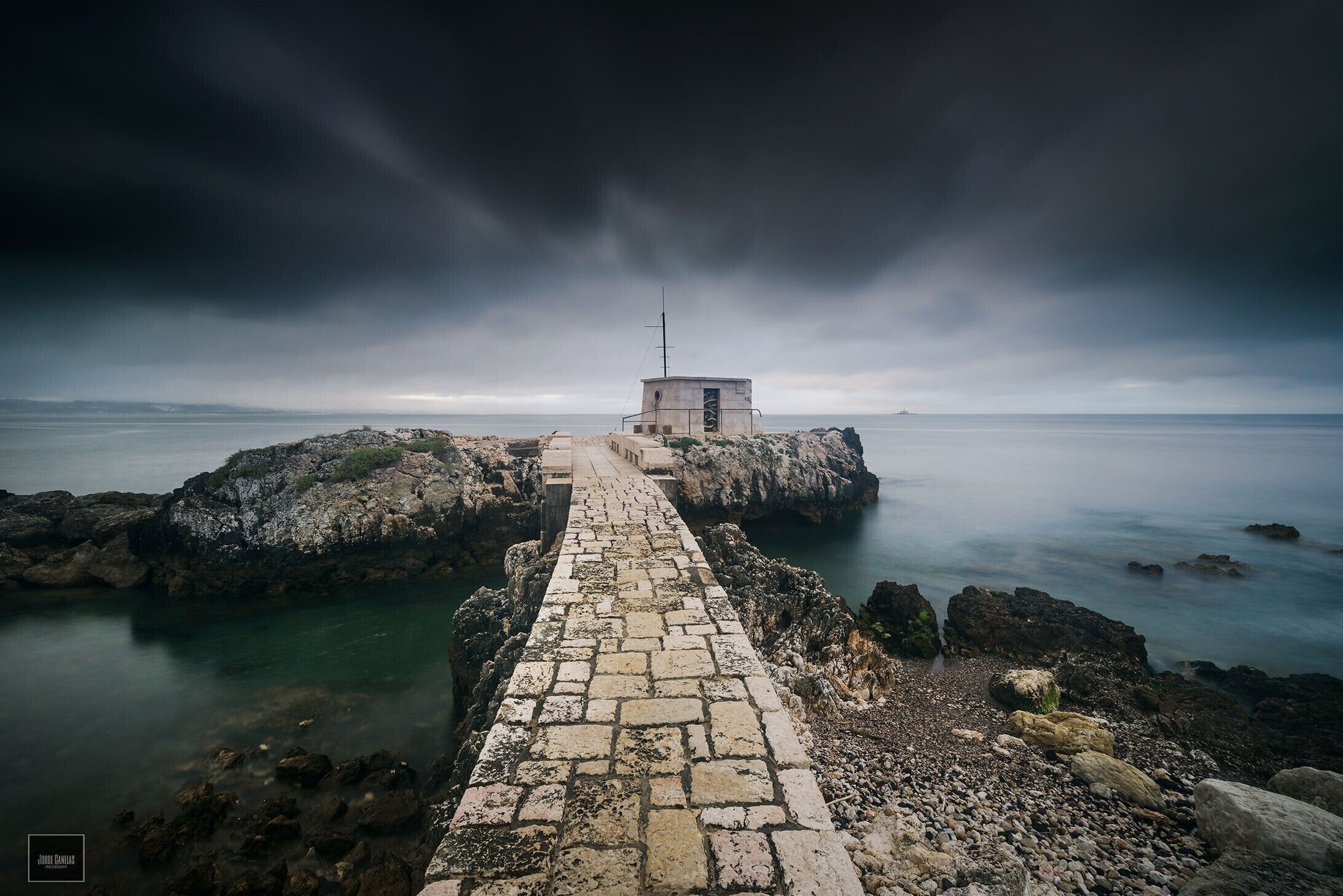 This is one place that I like to shot, is near Lisbon and you can do one fantastic Sunrise shot ( Yes, Sunrise) , it wasn't the case because there wasn't any colour in the Sky, after that you can do a long run in the Beach, I recommend Portugal to visit, fantastic, Country, amazing sites, good food and drink