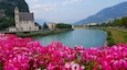 A river with a church and mountains in the background.