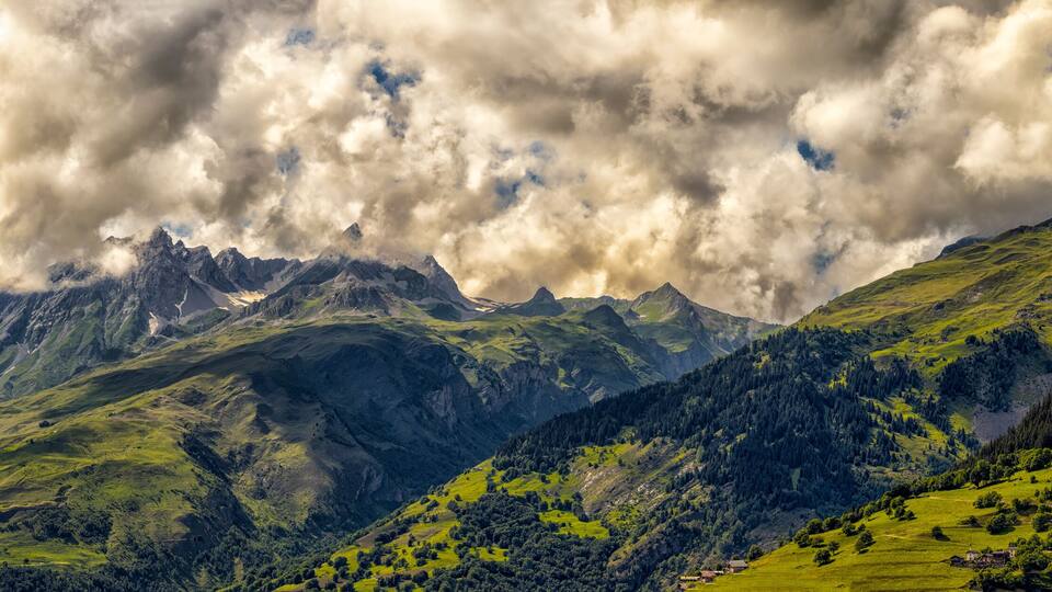 A mountainous landscape with lush green hills and a prominent peak.