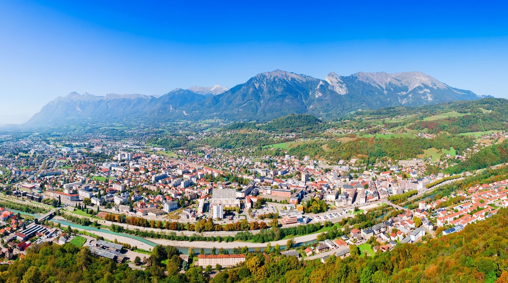 A panoramic view of a town nestled in a valley with mountains in the background.