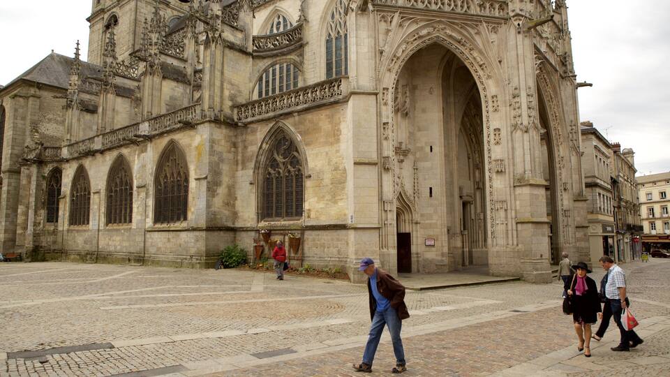A historic cathedral with large arched windows and intricate stone carvings.